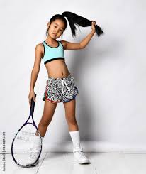 Badminton girl asian preteen model posing with racket full length ...